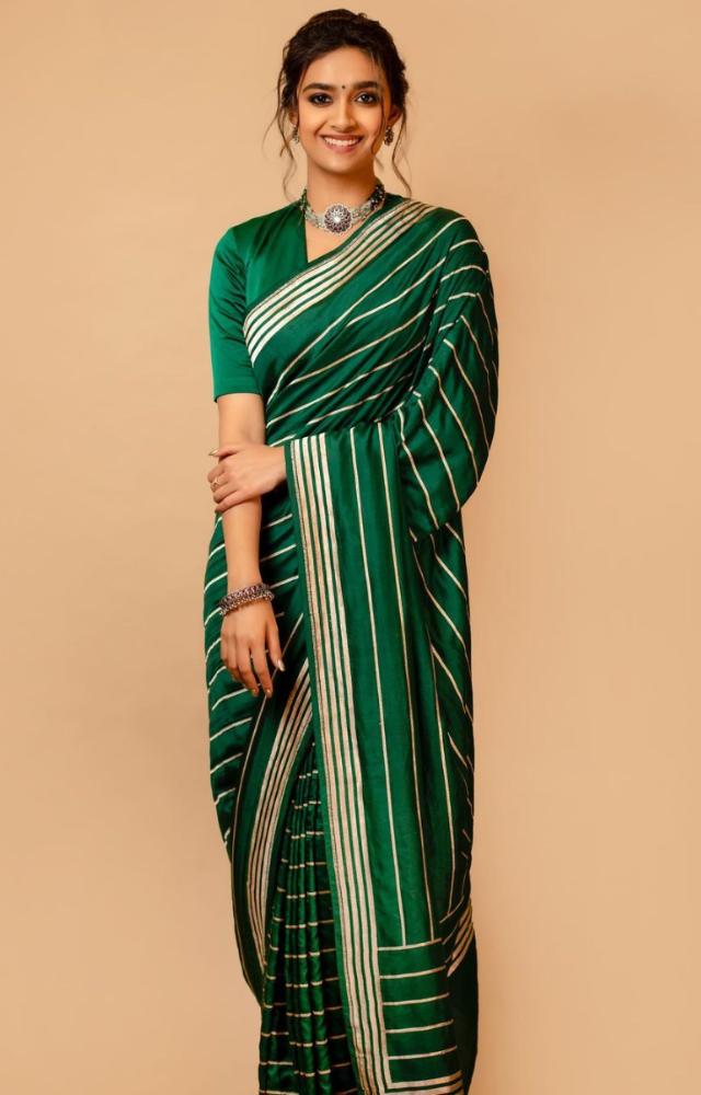 This bottle green saree with silver stripes can be a go to saree for every occassion 