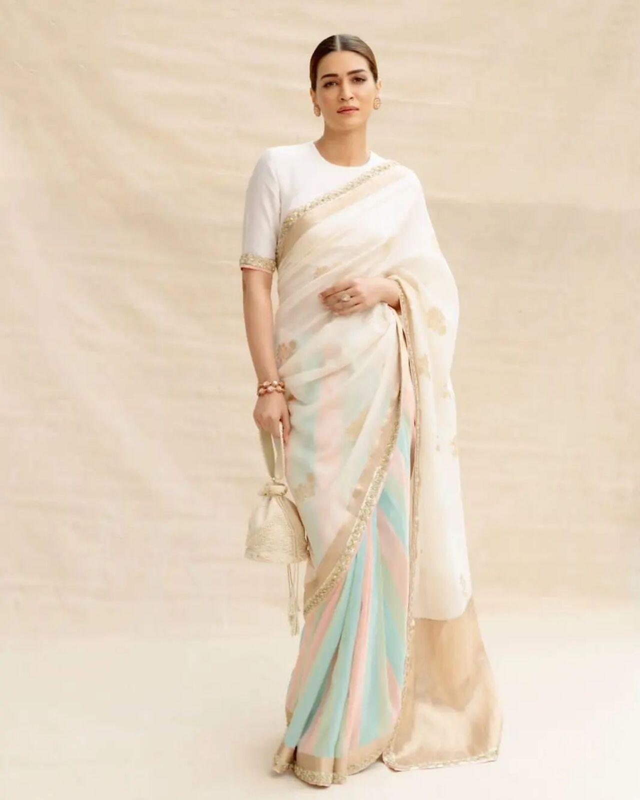 kriti Sanon attended the ceremony in a stunning cream-colored saree with hints of pink, green, and blue. She had her hair tied in a bun and adorned it with a beautiful 'Gajra'. (Pic/Spice Social Instagram)