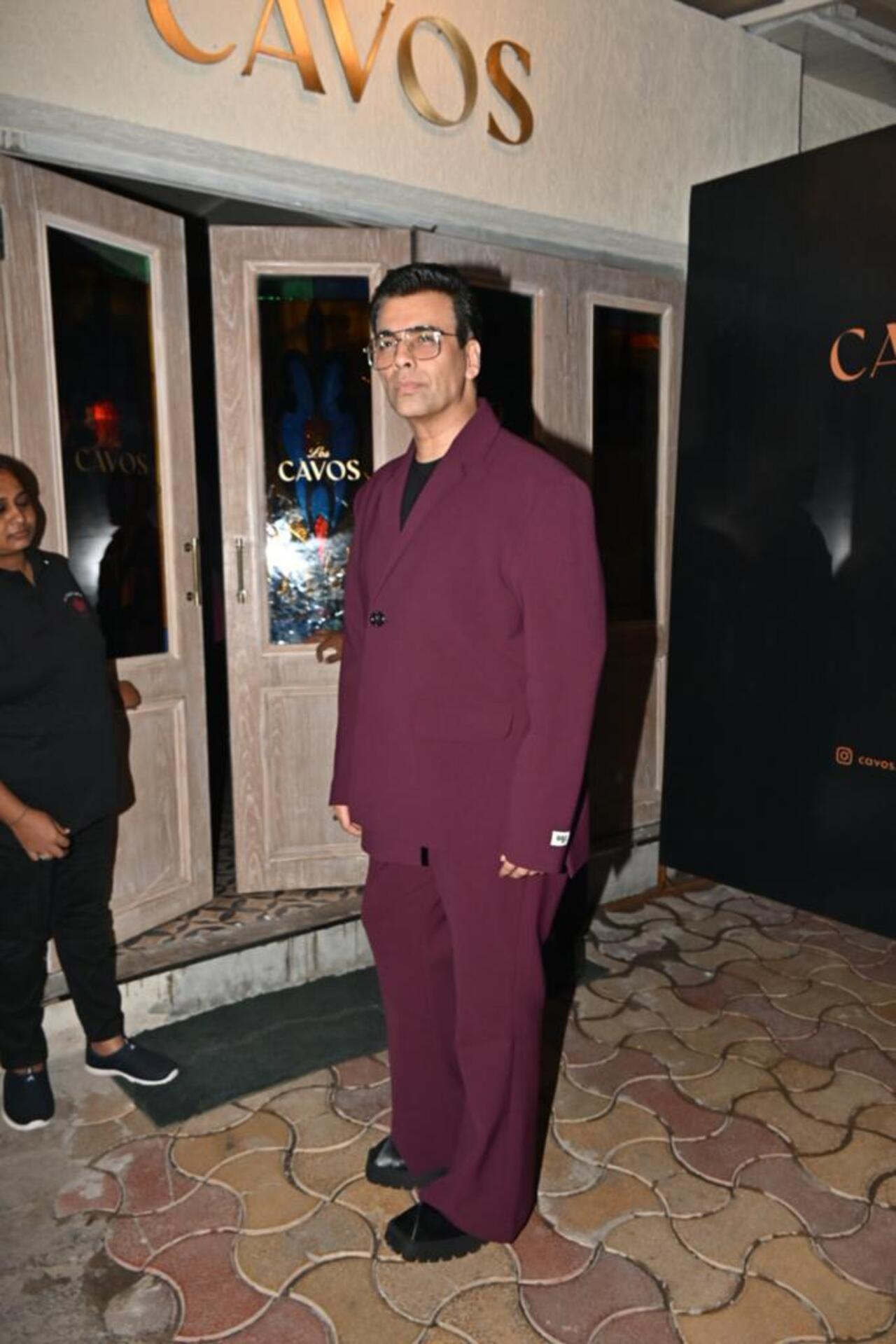 Filmmaker Karan Johar who is currently celebrating his 25th year in the movies as a director turned up in a wine-coloured suit
