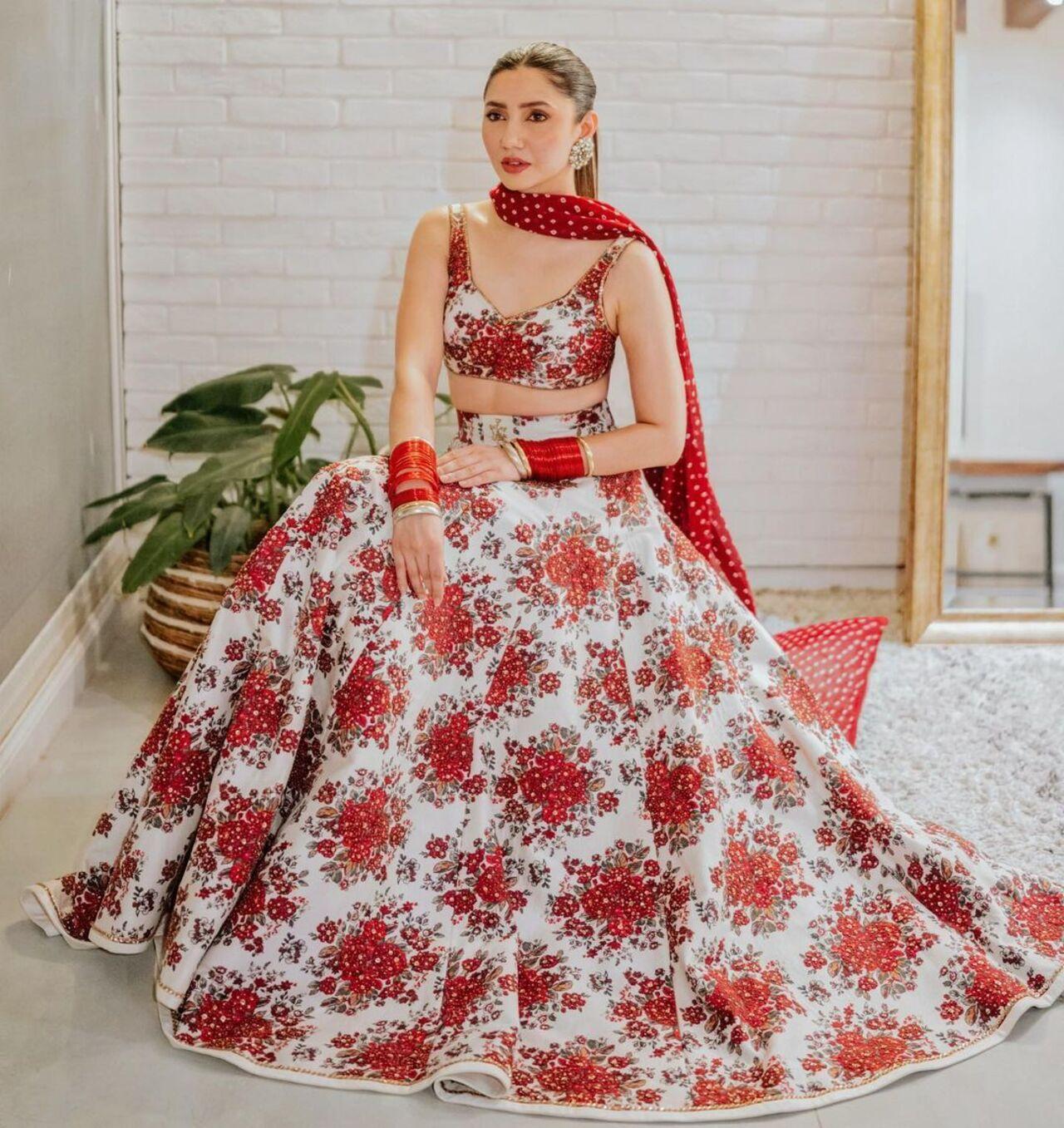 For her sangeet, Mahira brought in colours with her white lehenga covered in red floral prints. The red matched the blush on her face as she joyously celebrated her big day with her husband and loved ones