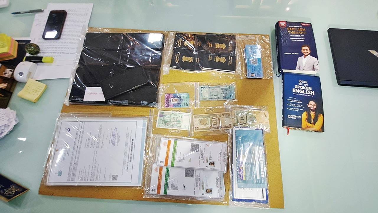 Phones and cash along with fake passports, ID cards and documents that were seized 