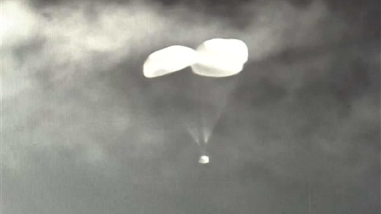 Crew module of ISRO's TV-D1 test flight of Mission Gaganyaan descends using parachutes before splashing down onto Bay of Bengal after successfully separating from the launch vehicle