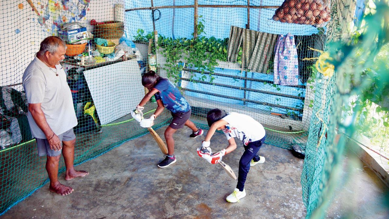 Coach Bharat Chamre training Mumbai U-15 player Snehlata Dhangada, 15, and nine-year-old Ambar Patil at his home in Wadrai pada, Kelve Mahim. Pics/Satej Shinde