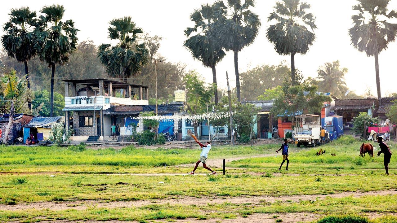 A small group of boys seen playing cricket after school in the coastal village of Satpati