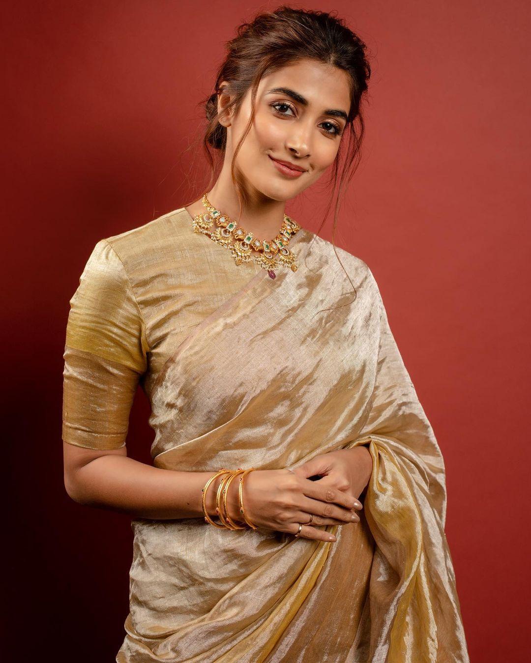 Pooja Hegde rocked a flawless Navratri look in her elegant saree. The saree she wore was a stunning ombré design with shades transitioning from a lighter metallic gold to a rich, dark gold. 