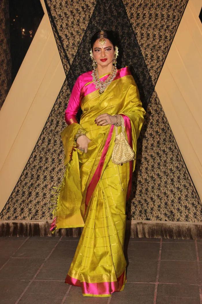 Rekha appeared at an event in a stunning mehendi green saree, beautifully accentuated with delicate pink borders