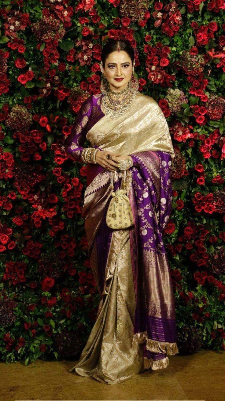 Rekha looked stunning at Deepika Padukone and Ranveer Singh's wedding reception. She wore a gorgeous gold and purple Kanjeevaram saree paired with a three-quarter sleeves banarasi silk blouse in a matching shade of purple
