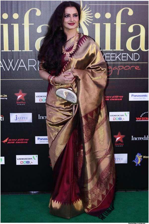 Rekha looked absolutely stunning in a beautiful handwoven Kanchi Pattu saree that blended gold and maroon colors.