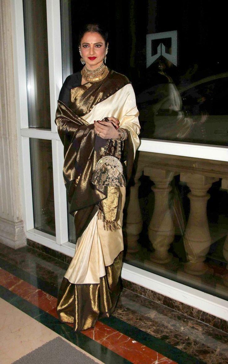 Rekha dazzled in a striking black and copper saree, featuring beautifully detailed white intricate designs.
