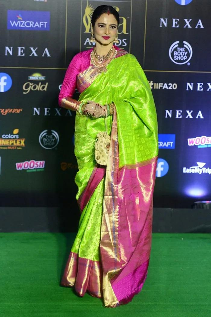 Rekha attended an event wearing a striking saree. The saree was an eye-catching neon green with vibrant pink borders