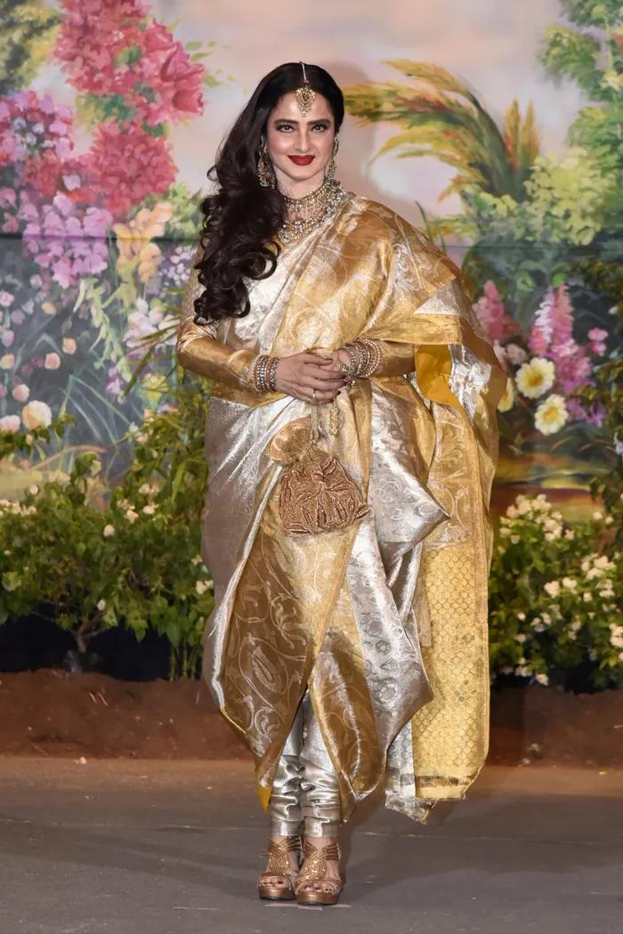Draped in a stunning white and gold saree styled in the dhoti fashion, Rekha looked absolutely enchanting