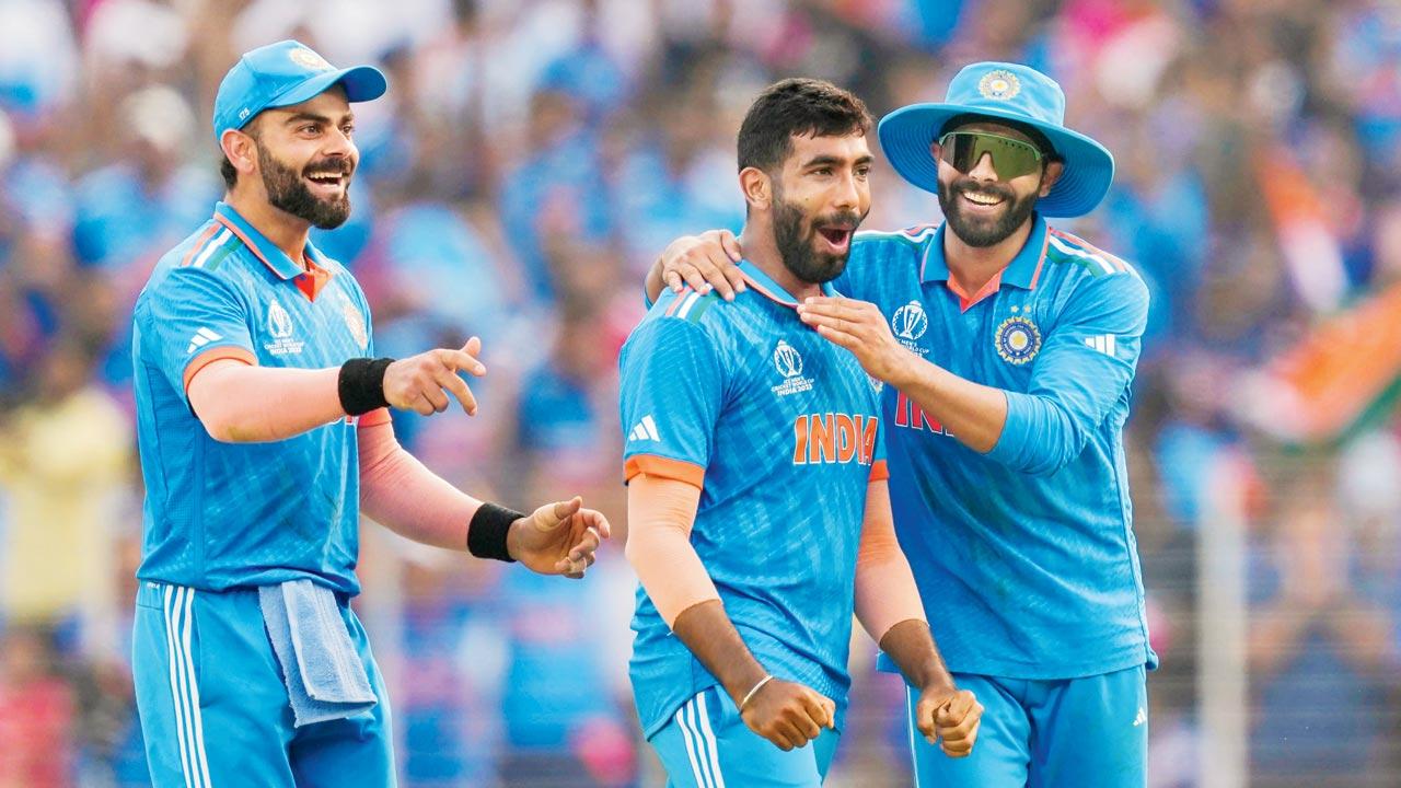 Jasprit Bumrah (centre) celebrates a wicket with Virat Kohli (left) and Ravindra Jadeja on Saturday