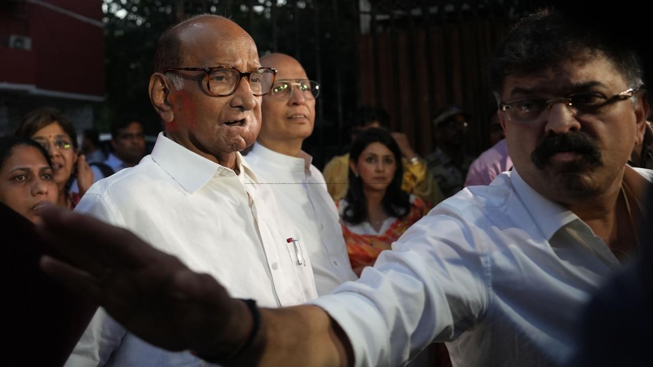 NCP chief Sharad Pawar and senior advocate Abhishek Manu Singhvi come out of the Election Commission office after the commission heard the plea of both factions over claims on the party's name and symbol. Pics/PTI