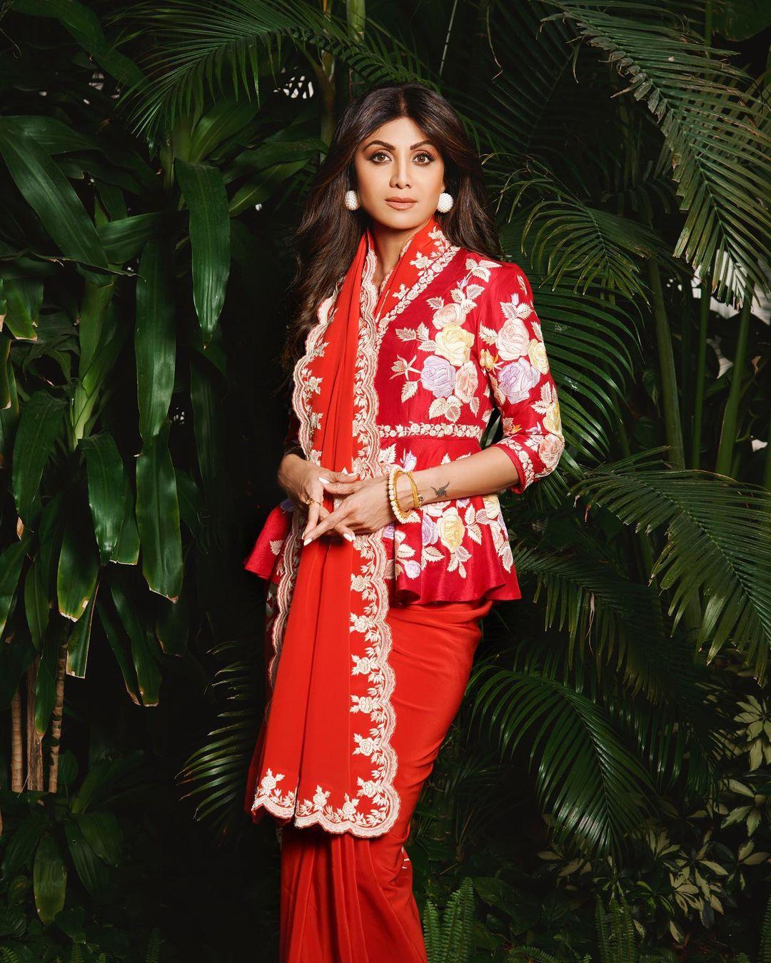 Shilpa Shetty looked absolutely gorgeous in a crimson saree she picked up from Ashdeen's collection. The saree had a unique peplum style and was adorned with a stunning pattern in soft white and pastel hues. The floral designs on the saree were so captivating, you couldn't help but be charmed by them. 