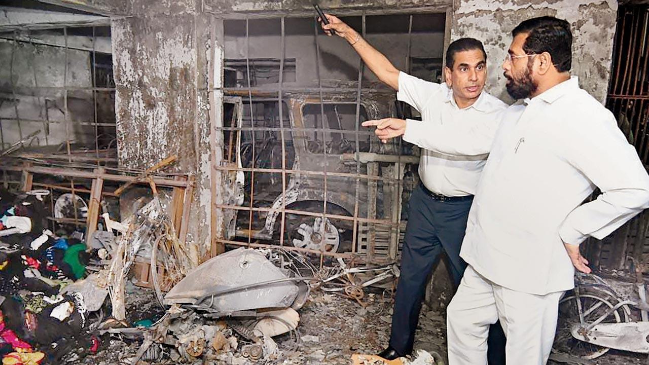 CM Eknath Shinde and BMC chief Iqbal Singh Chahal visit the SRA building in Goregaon West, where a fire broke out on October 6, killing seven people. The CM has directed officials to carry out fire audits of all SRA projects. Pic/PTI