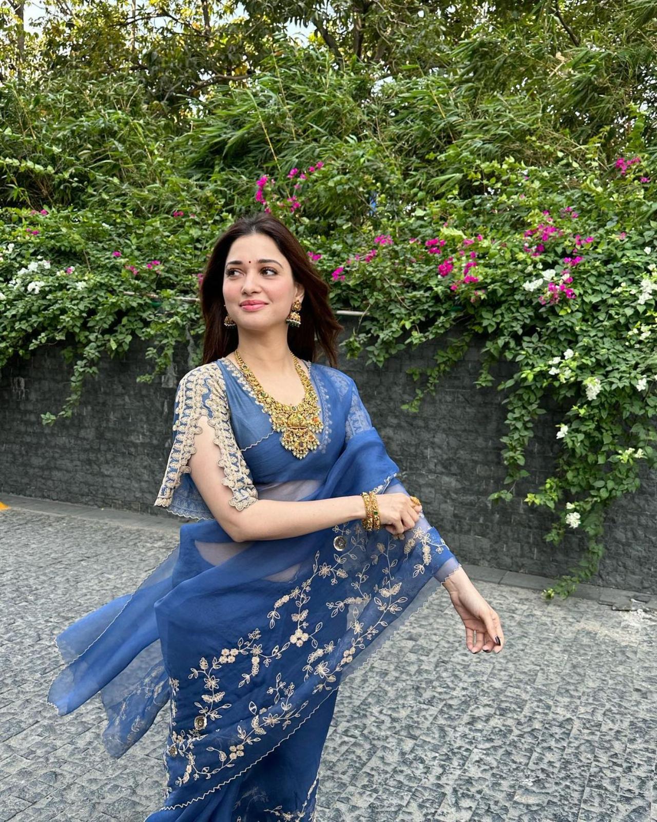 Tamannaah Bhatia shows how to keep it light and stylish with this sheer saree with silver embroidery. The actress paired the outfit with heavy gold jewellery
