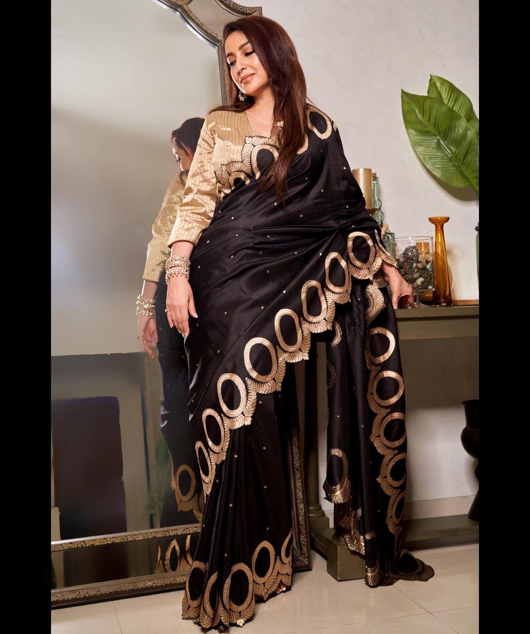 Tisca Chopra stuns in a black saree with gold details, thanks to some stylish guidance from @stylemuze. She chose a saree from @raw_mango and added some sparkle with @anmoljewellers accessories. To complete the look, she wore @gianvitorossi shoes. 