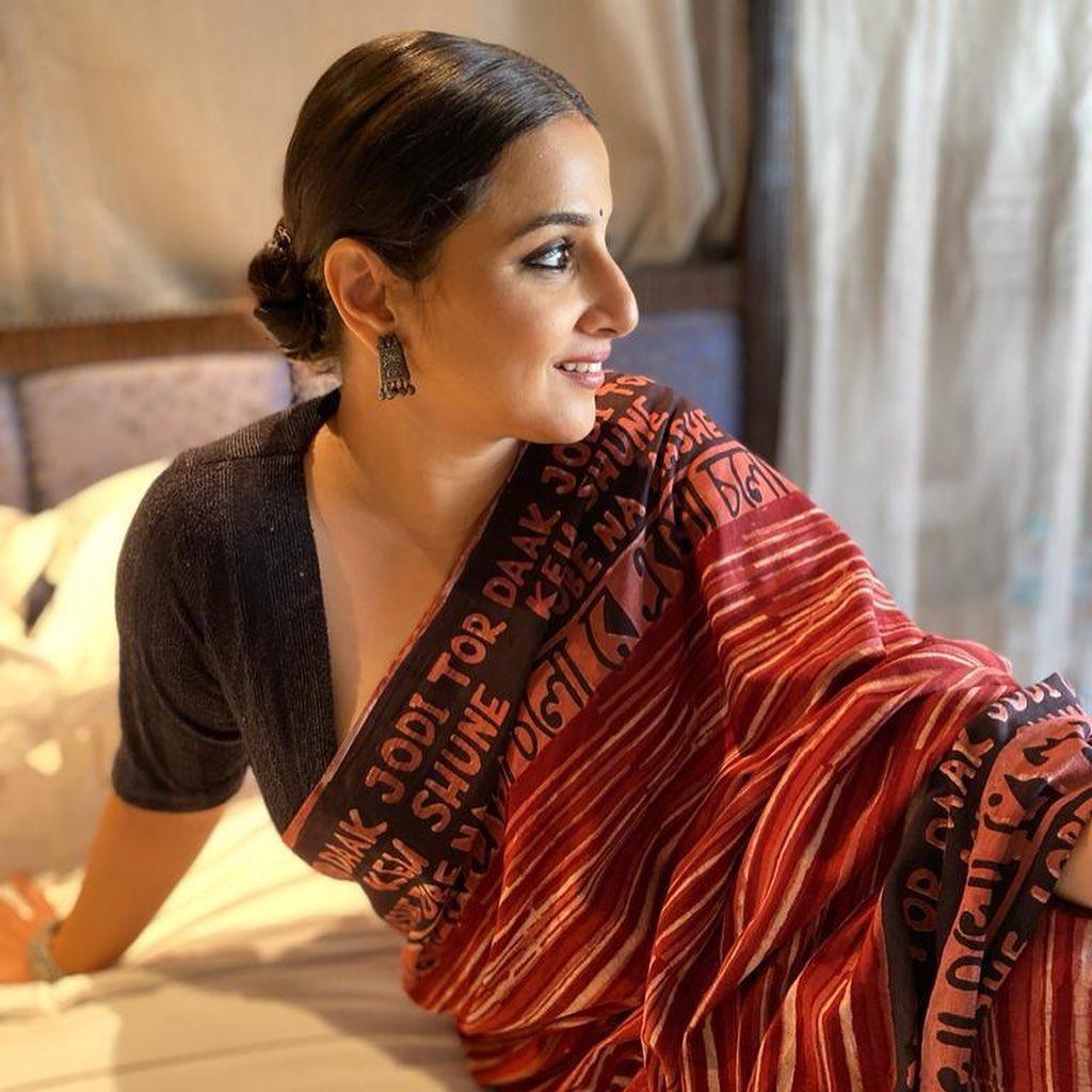 Vidya Balan looks absolutely amazing in a dark red printed saree paired with a stylish black half-sleeve blouse. Her outfit goes beyond just fashion and makes for a fantastic pick for Ashtami.