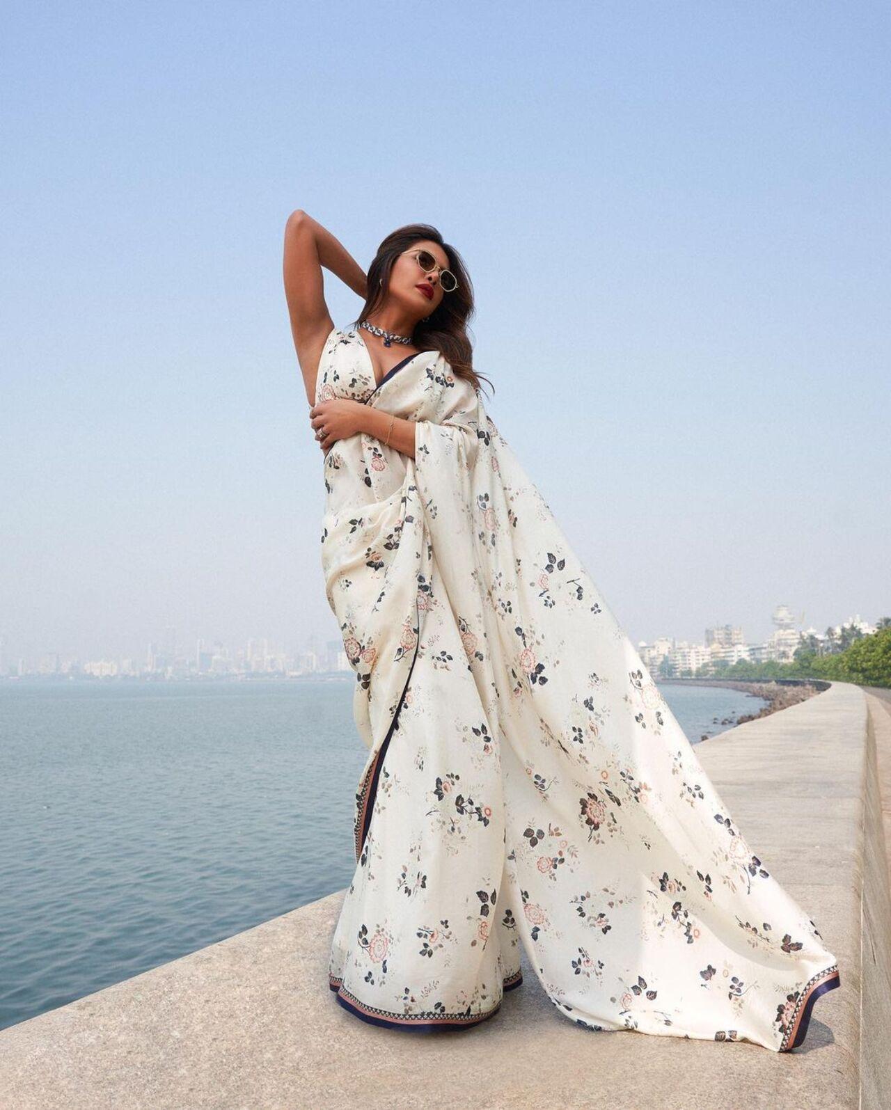 Priyanka gracefully carried this white Sabyasachi saree for a conversation on films at the MAMI Mumbai film festival. While the saree has a navy blue border with floral prints, one can also look stunning with a black border saree