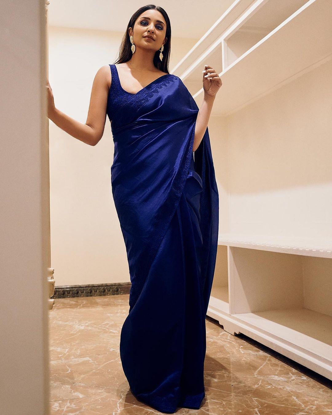If you find yourself in the role of a bridesmaid, juggling numerous responsibilities for your best friend's wedding, a simple yet chic saree can be your perfect choice. Parineeti's elegant blue saree serves as an excellent option for a glamorous and sophisticated look 