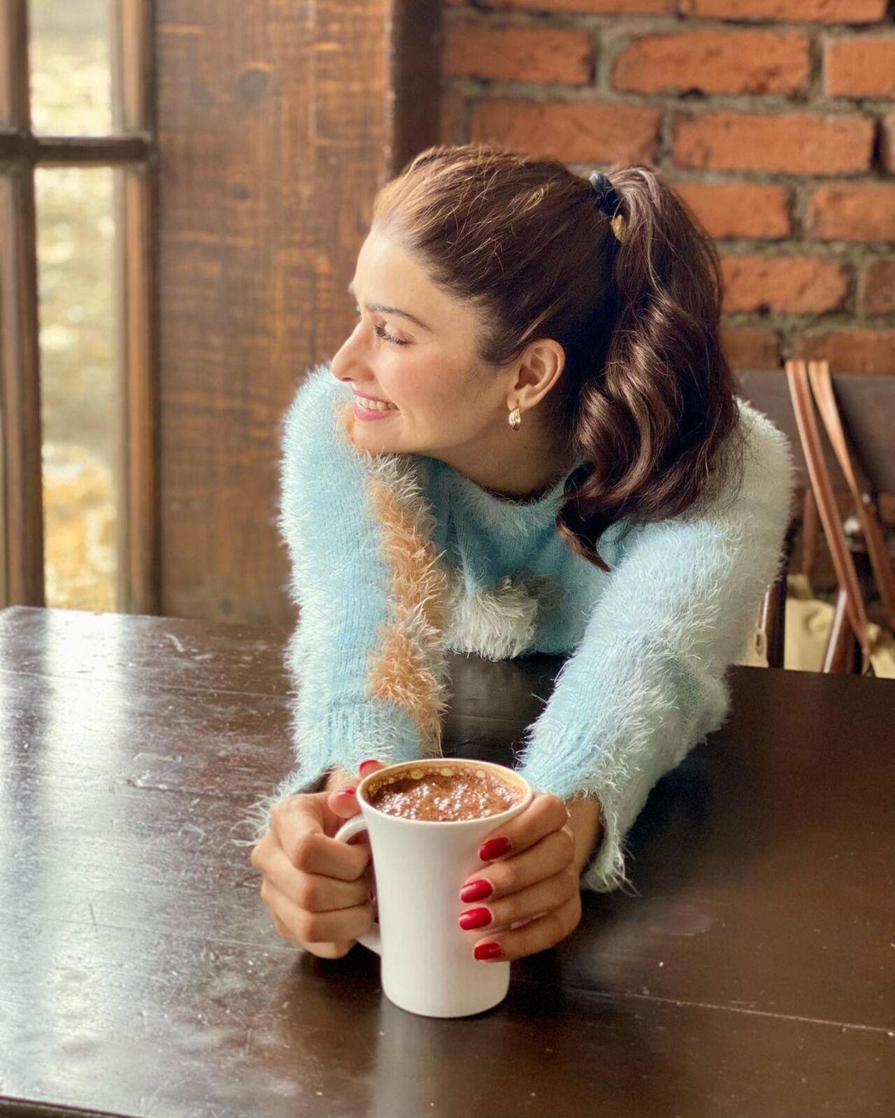 Prachi Desai, adorned in a stunning blue sweater, posed for a candid picture, sipping her coffee