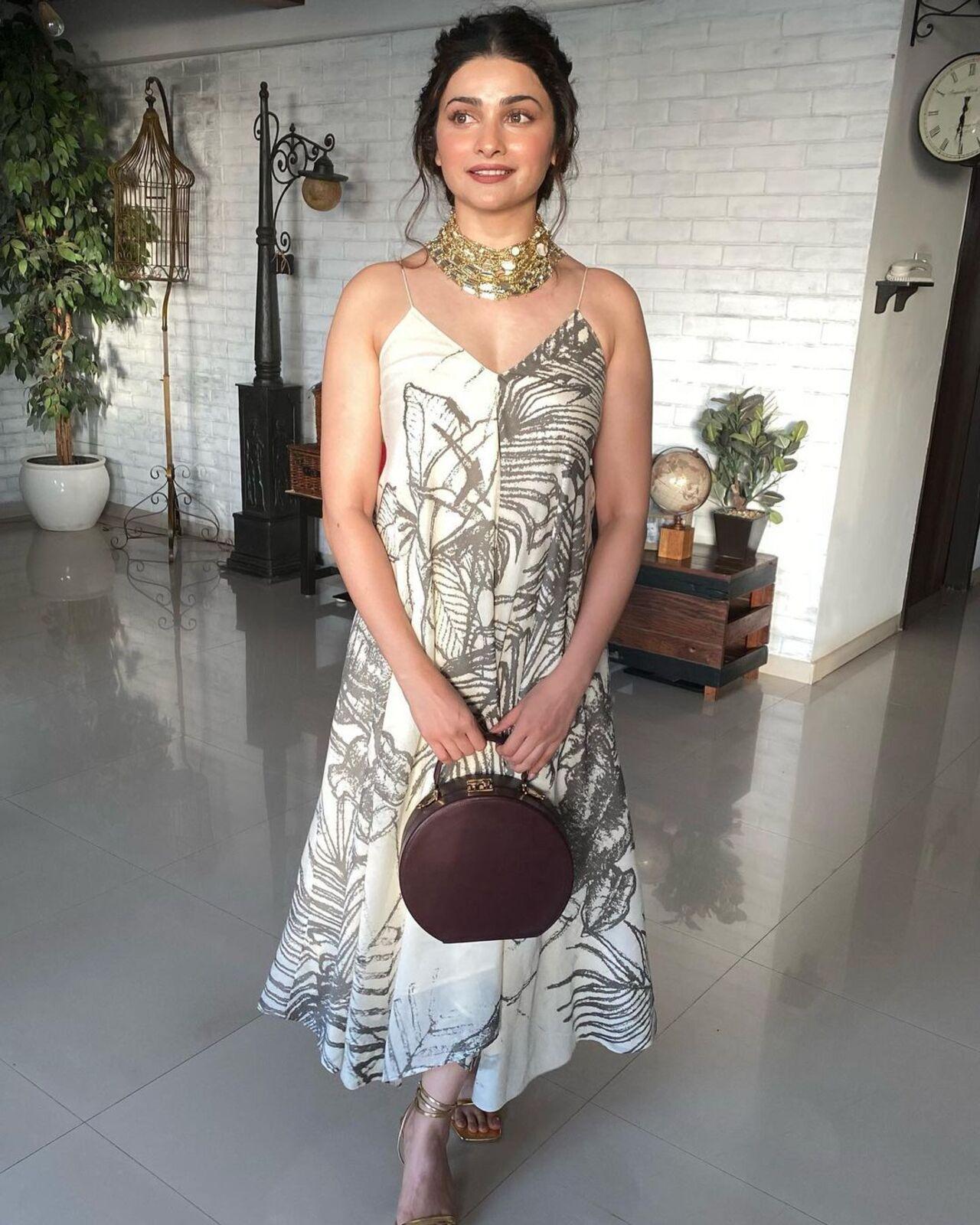 Prachi Desai looked effortlessly chic in her choice of attire. She donned a light-coloured printed dress that perfectly complemented the daytime occasion. With her hair elegantly tied in a messy bun, she radiated a casual yet sophisticated charm