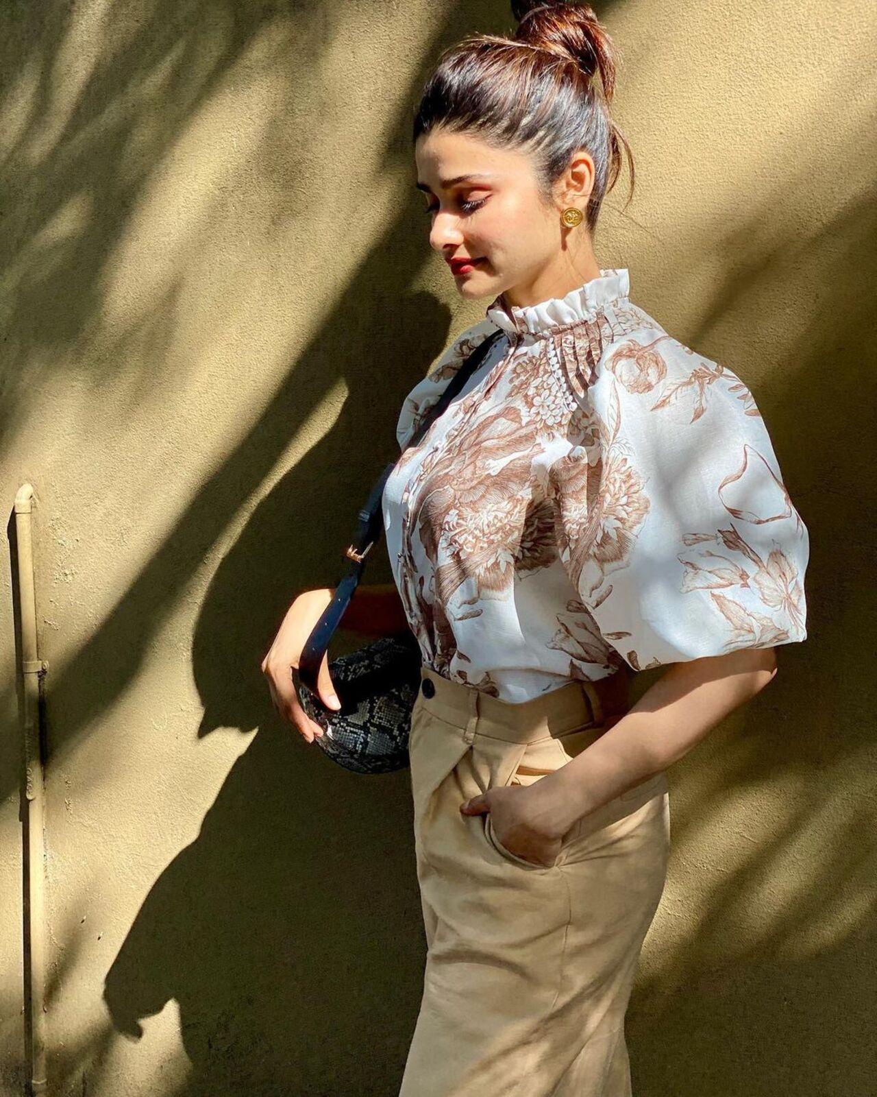 Prachi Desai effortlessly stole the spotlight as she stepped out in a stylish ensemble. She opted for a casual yet chic look, pairing a beige-coloured pant with a crisp white top adorned with intricate brown designs