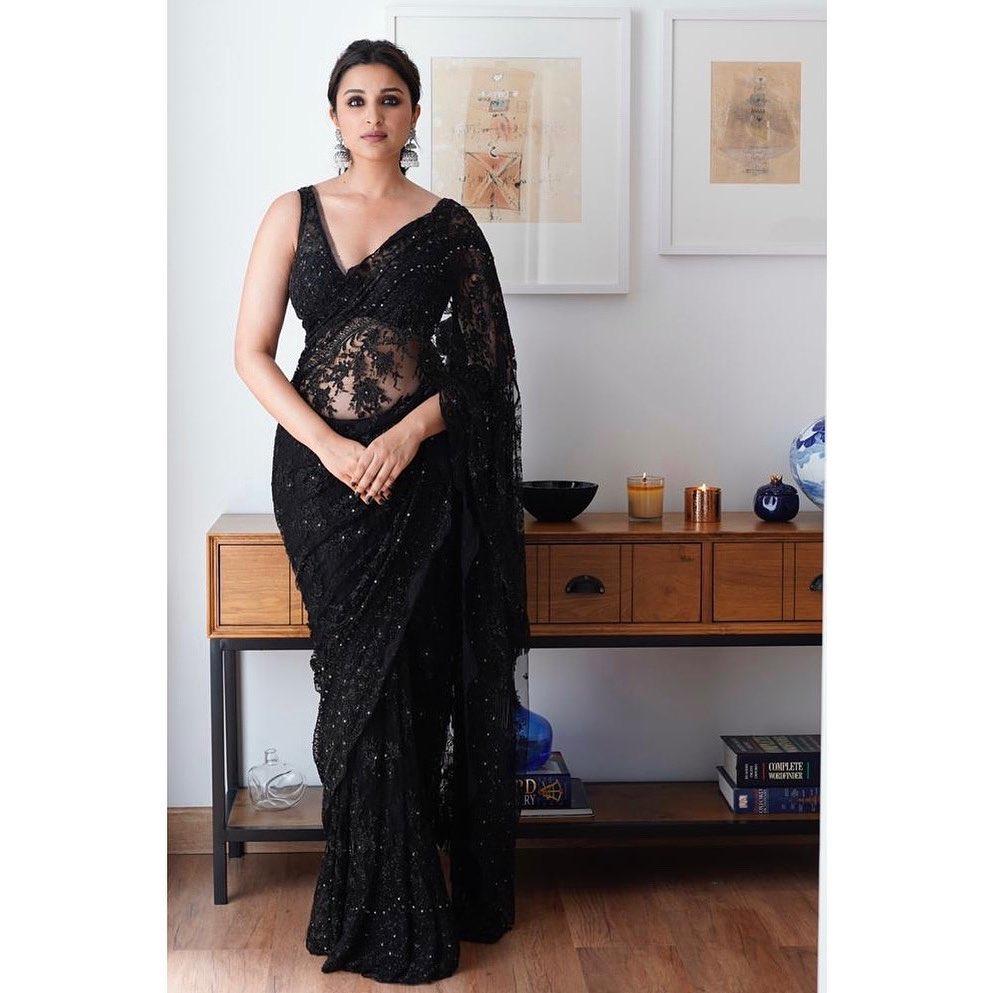 Another black saree worn by Parineeti Chopra, and this one also made our hearts skip a beat. The actress tied her hair in a chic ponytail while she opted for a pair of oxidized jhumkas to maintain a balance between glamour and grace