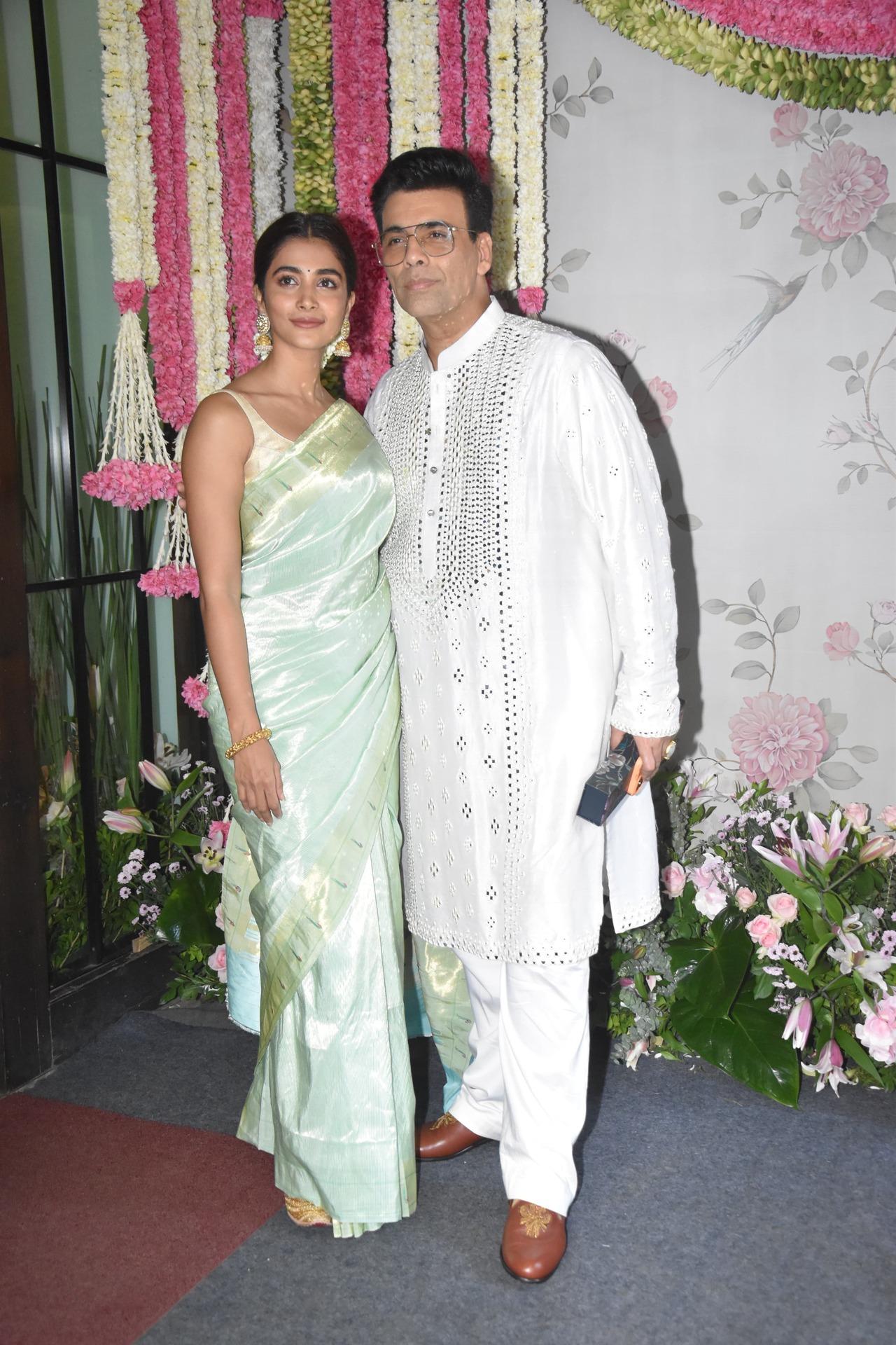 Karan Johar and Pooja Hegde posed together for the paparazzi at Arpita's Ganpati celebration