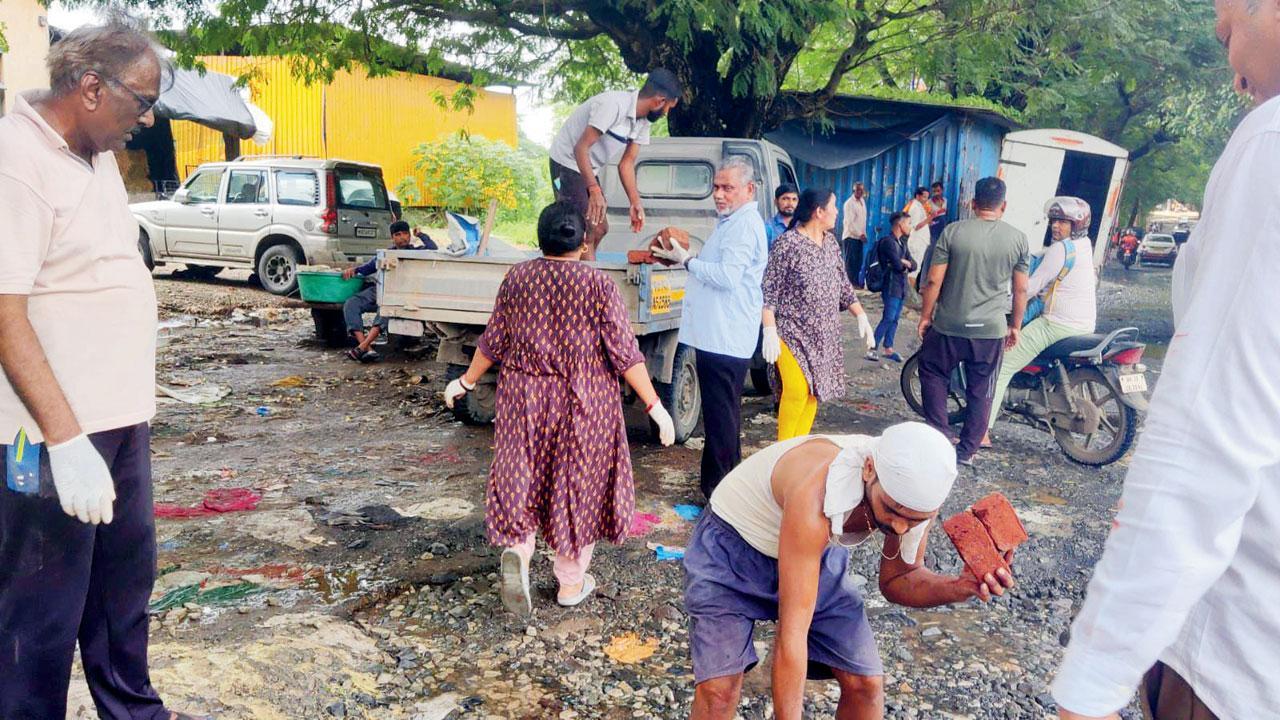 Mumbai: Fed-up of inaction, Aarey residents fix potholes in area