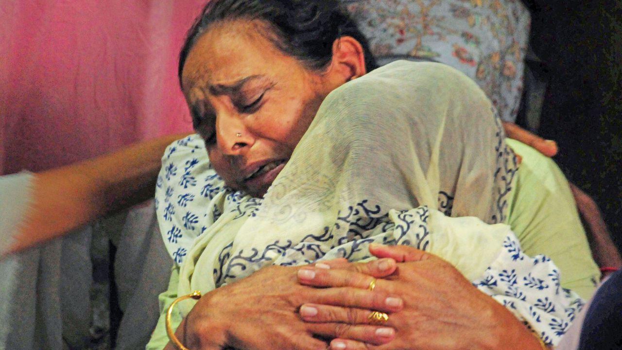 The Colonel's mother was seen mourning her son's death as she waited at her doorstep for his mortal remains. 