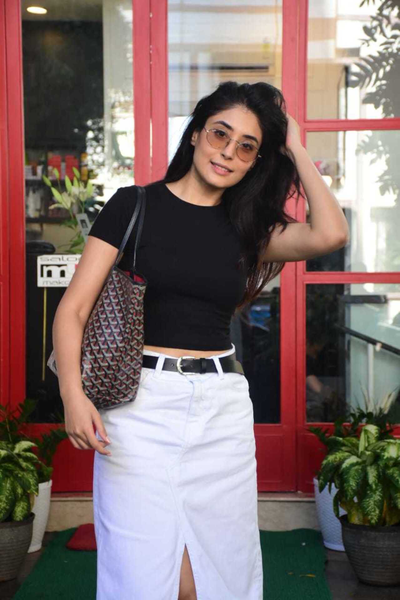The actress looked smart in a black top and white bottoms