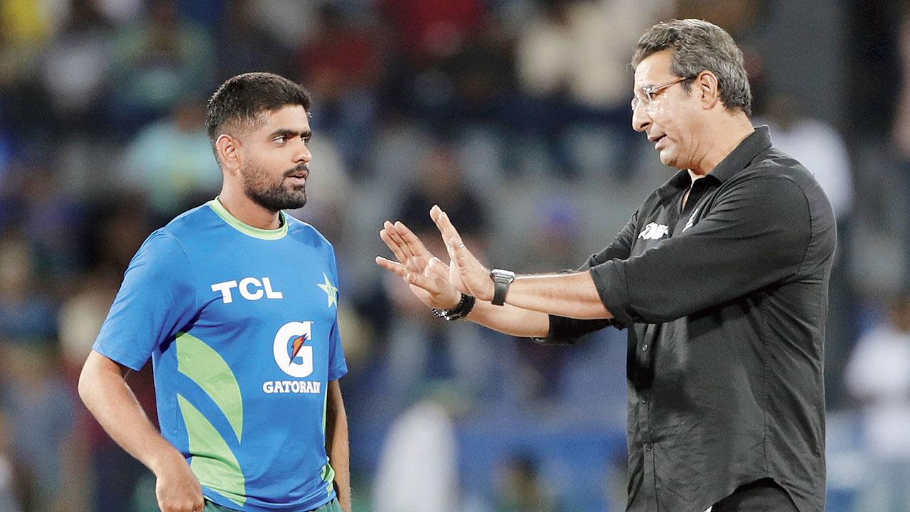 Pakistan captain Babar Azam (left) in conversation with former skipper and 1992 World Cup star Wasim Akram during the Asia Cup Super Four match against India at the R Premadasa Stadium in Colombo on September 10. PIC/GETTY IMAGES