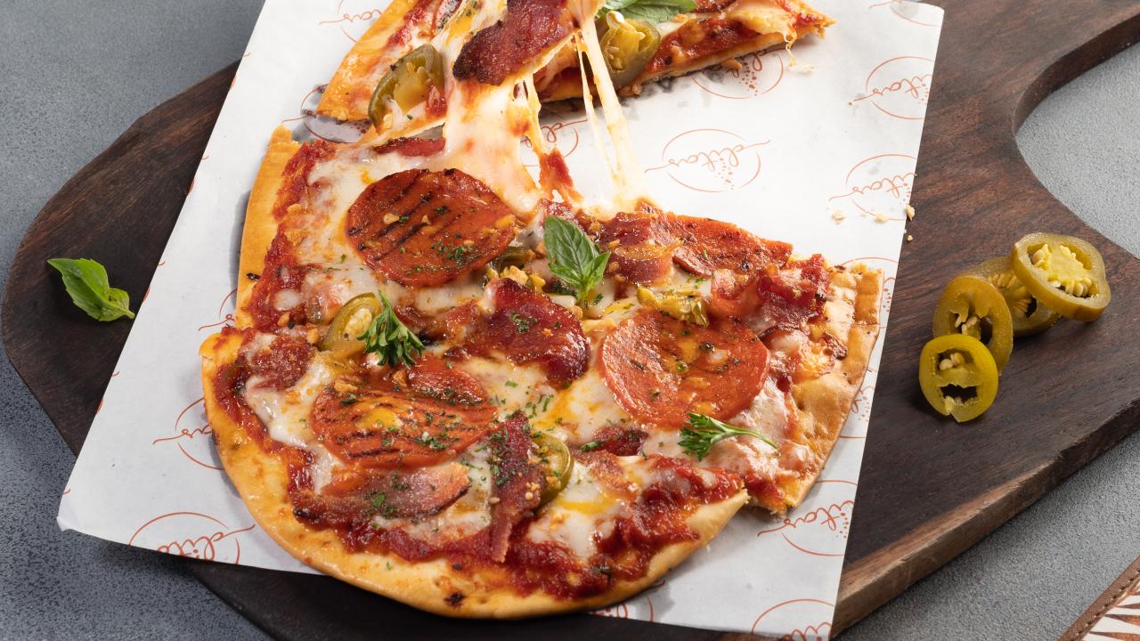 At Ditas, executive chef Ravi Ranjan makes a pepperoni and bacon flatbread that they like to call Pizzaroni. When used in a pizza, he says it adds a sweet, smoky, and salty flavour rounded out with unctuous notes from the fatty pork belly muscle. Photo Courtesy: Ditas