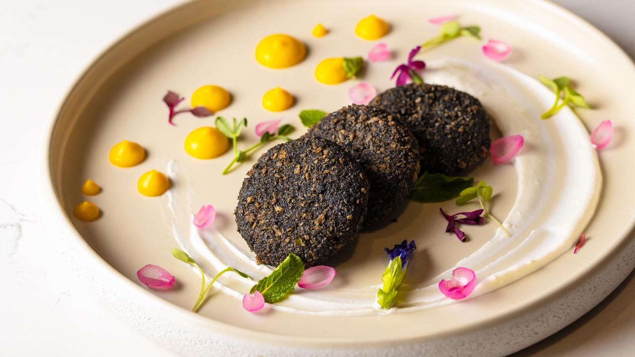 Chef Abhijeet Bagwe, who is the executive chef at Novotel Mumbai International Airport in Andheri recommends making an elaborate activated charcoal-infused dahi ke kebab to relish for the festival. He says the yogurt's soft tanginess harmonises seamlessly with the smoky nuances from the charcoal infusion, enriching the overall taste experience. Photo Courtesy: Novotel Mumbai International Airport