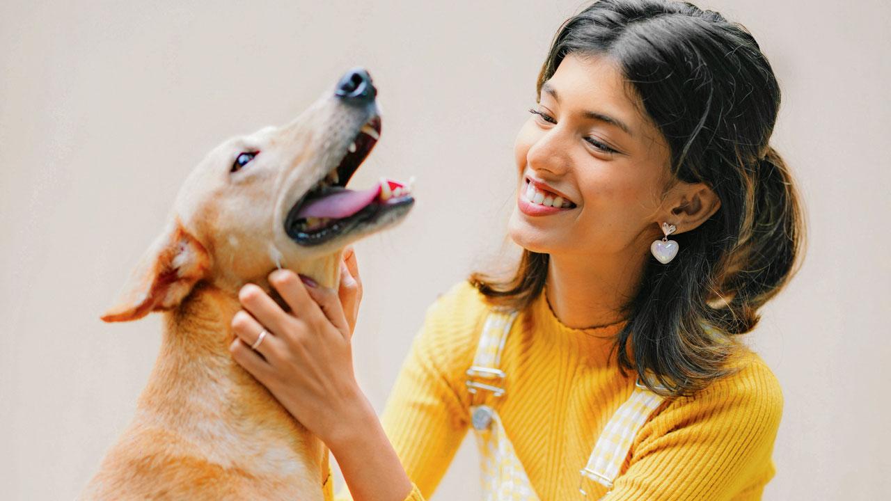 Ugale with a dog at the shelter