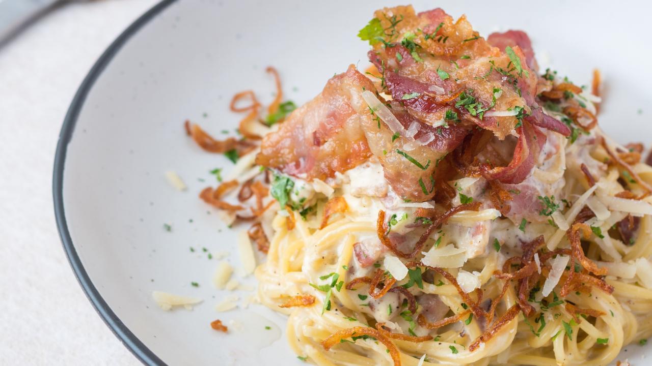 At Smoke House Deli, chef Rollin Lasrado makes a Bacon Carbonara because he says traditional carbonara uses guanciale, Pecorino, and eggs. In India, where guanciale is rarer, bacon stands as an excellent substitute. Photo Courtesy: Smoke House Deli