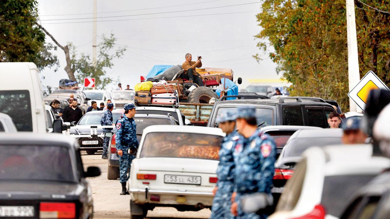 Refugees wait in vehicles near the border town of Kornidzor, Armenia. PIC/AP