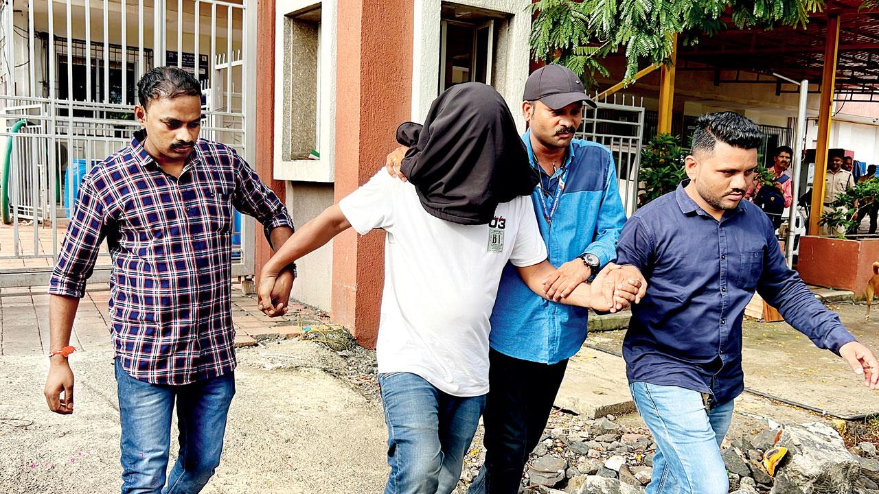The male accused being led away by the cops