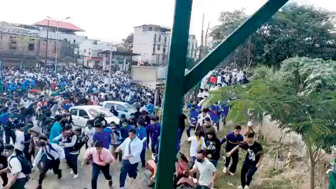 Screengrab of viral video shows students running after teargas is thrown at  them. Pic/Twitter