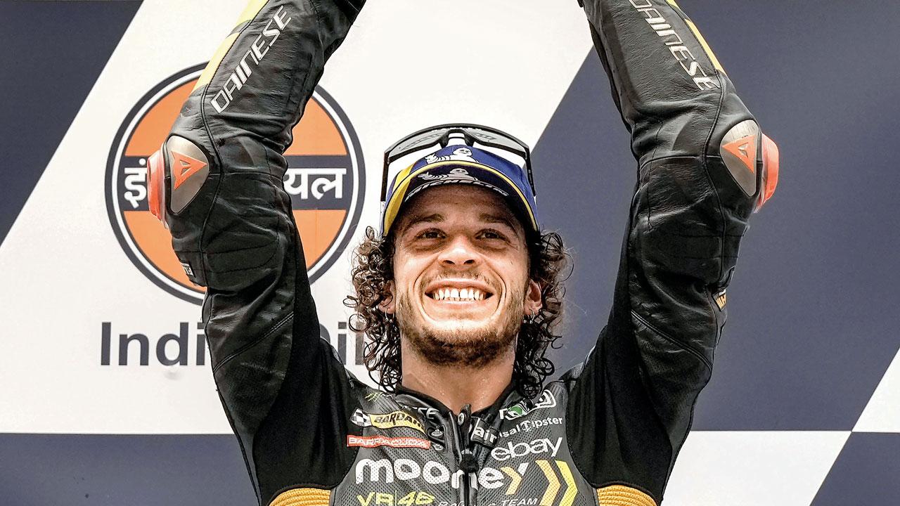 Marco Bezzecchi celebrates on the podium in Greater Noida
