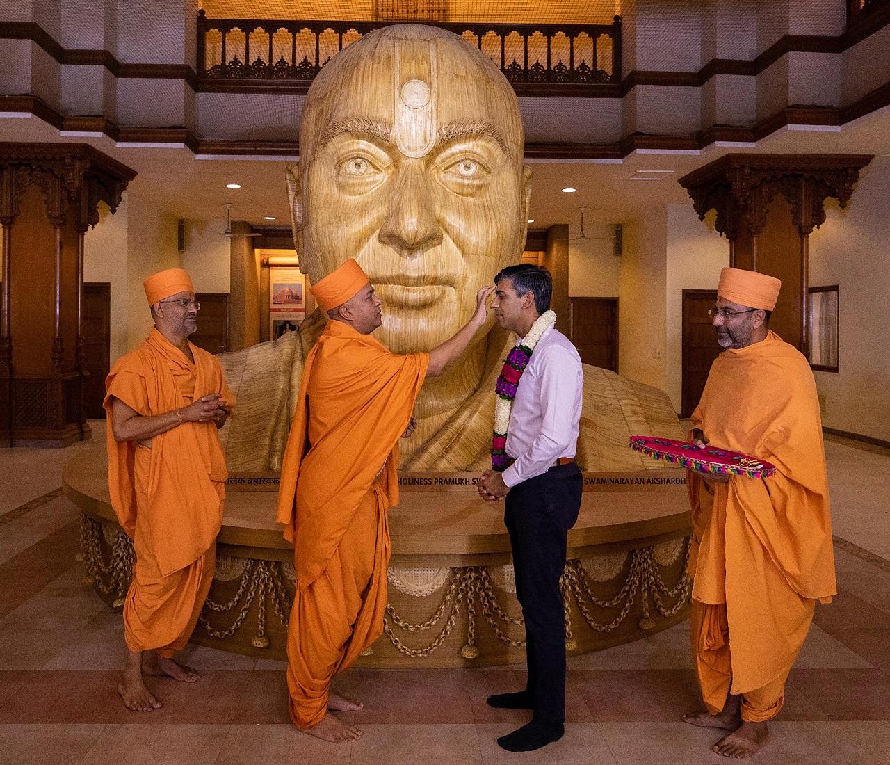 They reached the temple dedicated to Swaminarayan, believed to be an incarnation of Lord Vishnu, early morning and walked barefoot from the reception area to the main temple complex -- a distance of about 150 metres