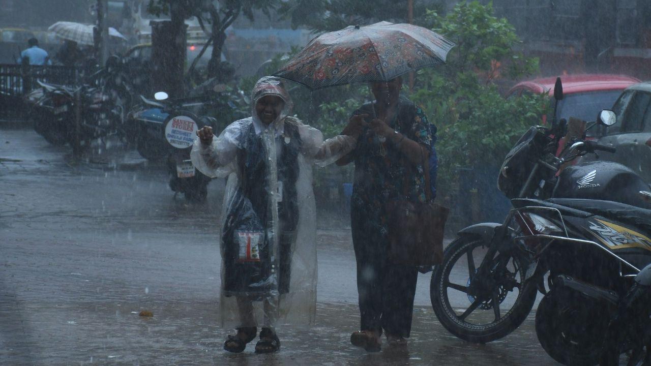 Even as the rain poured down, it did not dampen people's joy. A mother-child duo happily walked back home amid heavy shower.