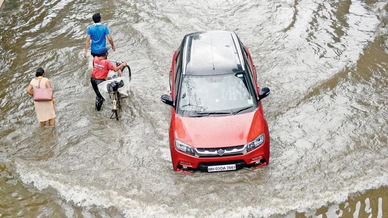 Thane: Two persons rescued after car gets stuck in swollen drain