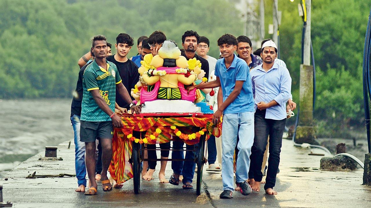 A small group of devotees cart their idol to the Gorai jetty in Borivli West. Pic/Nimesh Dave