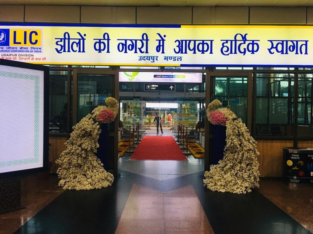 The exit of the airport has also been adorned with flowers and other decorative elements. A red carpet has also been set up near the exit. An elaborate peacock shaped flower decoration welcomed the couple into the city