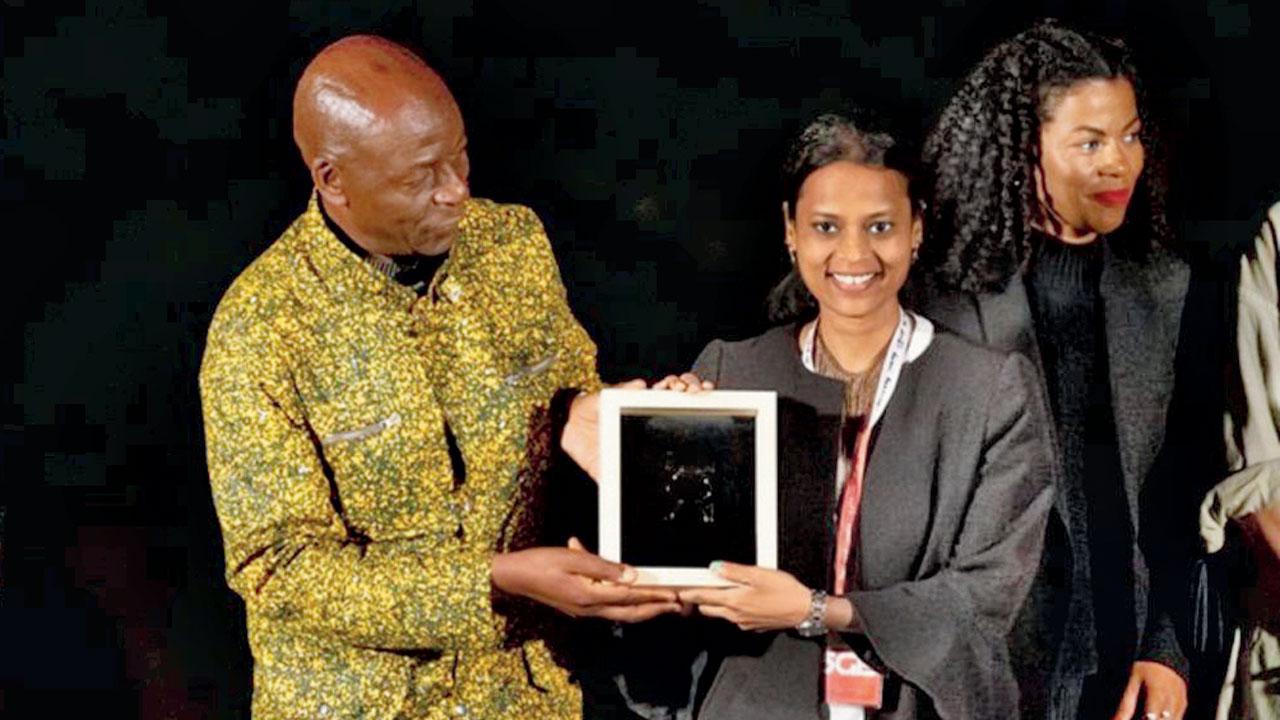 Sonawane (centre) receives the Grand Prize from the jury
