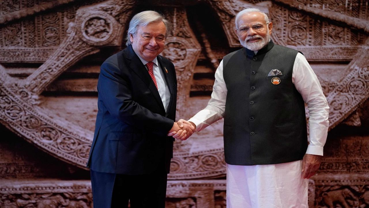 India's Prime Minister Narendra Modi (R) shakes hand with United Nations Secretary General Antonio Guterres ahead of the G20 Leaders' Summit at the Bharat Mandapam in New Delhi on September 9, 2023. 