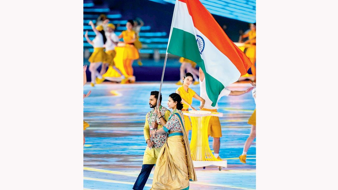 Flagbearers Lovlina Borgohain and Harmanpreet Singh lead the Indian contingent during the Opening Ceremony on Saturday