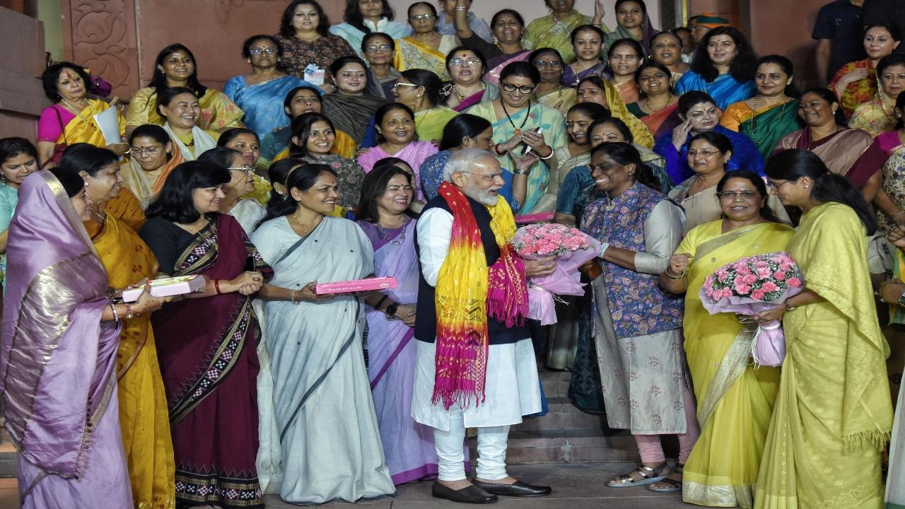 Women members from both Houses of Parliament, including PT Usha, and Union Ministers Meenakashi Lekhi and Smriti Irani, were all smiles as they presented a bouquet to Prime Minister Modi on the historic passage of the Bill in Parliament.